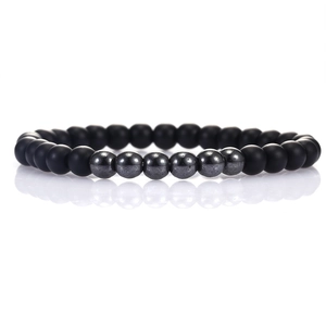 Detailed macro view of matte black obsidian and metallic hematite beaded bracelet