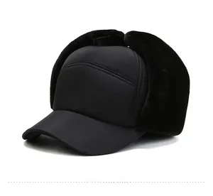 Detail view of winter ear flap hat with black windproof fabric and thick faux fur lining