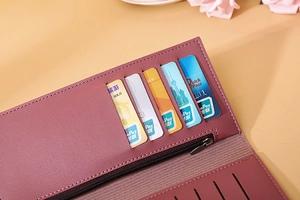 Detailed interior of a long pale mauve leather wallet with multiple card slots and zipper