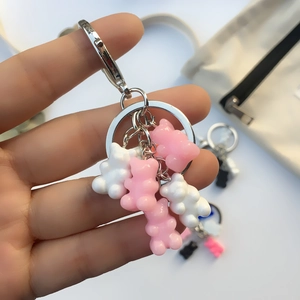 Close-up of pink and white resin gummy bear charms on a silver metal keychain
