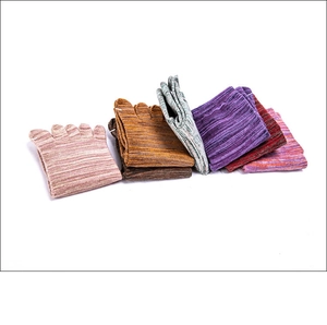 Folded colorful cotton five-toe yoga socks in pink, brown, green and purple colors