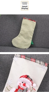 Detail view of rustic burlap Christmas stocking with snowman decor and plaid trim