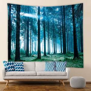 Deep blue forest tapestry with morning sun rays hanging over a white sofa in a room