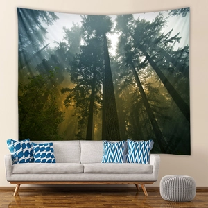 Detailed view of forest tapestry with sunlight beams hanging over a cozy living room sofa