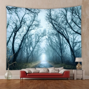 Detail of bohemian misty forest tapestry hanging above a sofa for wall decoration