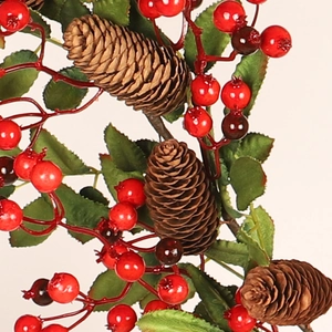 Artificial Christmas garland with red berries, natural pine cones and green foliage on white