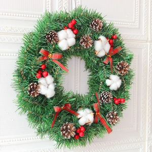 Christmas wreath with cotton, pine cones, red berries and festive plaid bows on white background