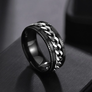 Macro shot of men's black titanium steel ring with a rotatable silver chain inlay