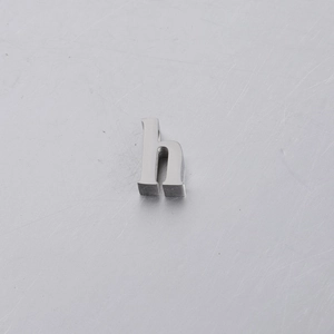Macro shot of 10mm mirror polished stainless steel alphabet letter h slider bead