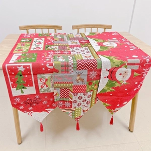 Detailed knit Christmas table runners with red tassels, reindeer, and snowman patterns