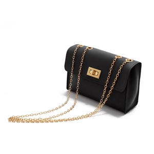 Detail of black PU leather mini square bag with gold chain strap and turn-lock closure