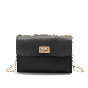 Detail of black PU leather mini crossbody bag with gold chain strap and turn-lock closure