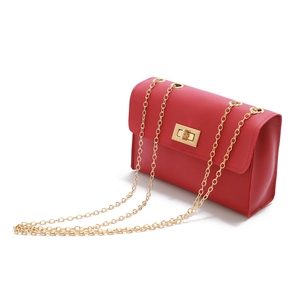 Detailed view of red PU leather mini crossbody bag with golden chain strap and buckle lock