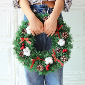 Classic Christmas wreath with red berries and pine cones for festive home door decoration