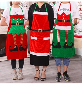 Detailed view of three festive Christmas aprons with Santa and elf designs for parties