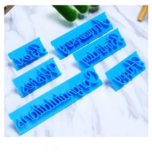 Blue plastic letter stamps for cake decorating with Best Wishes and Happy Birthday text