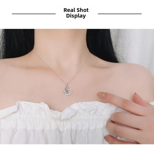 Close-up of S925 sterling silver moon and cat pendant necklace with zircon on neck