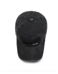 Top view of washed black denim baseball cap with vintage embroidery and stitched eyelets