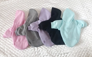 Close-up of five colorful fleece pet hoodies in pink, gray, purple, black, and blue colors