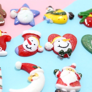 Detailed view of colorful Christmas resin charms like Santa, snowmen and glitter stars