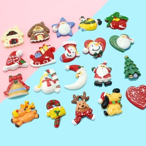 Flat lay of 19 colorful Christmas resin charms including Santa, snowmen and gingerbread houses