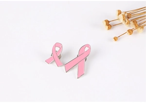 Detail of pink ribbon enamel pins in two sizes with silver metal trim and butterfly clutch