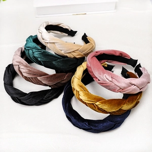 Stack of colorful braided velvet headbands showing soft texture and vintage craftsmanship