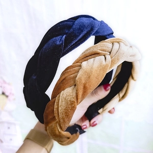 Detail of twisted velvet headbands in navy blue and caramel brown colors