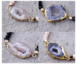 Macro detail of natural druzy agate connectors with gold plated edges and faceted beads