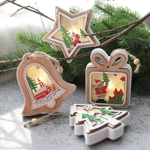 Wooden Christmas LED star bell tree ornaments with warm lights on a gray backdrop