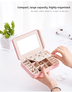 Pink portable faux leather jewelry box with mirrors and slots for rings and earrings