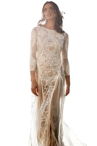 Detail of elegant white lace dress with long sleeves and delicate floral embroidery pattern