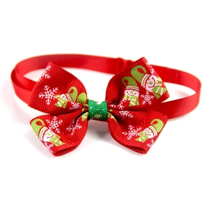 Red Christmas pet bow tie with snowflake and gnome patterns on adjustable neck strap