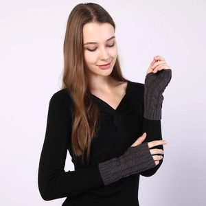 Close-up of cable-knit pattern on dark grey fingerless gloves for winter warmth