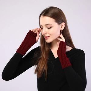 Detail of wine red cable knit fingerless gloves showing soft texture and arm sleeve design