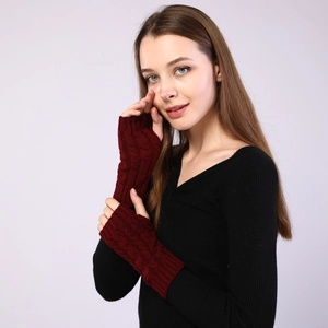 Detailed cable knit pattern on burgundy fingerless arm warmers for winter comfort