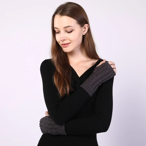 Detailed texture of dark grey cable knit pattern on warm winter fingerless arm warmers