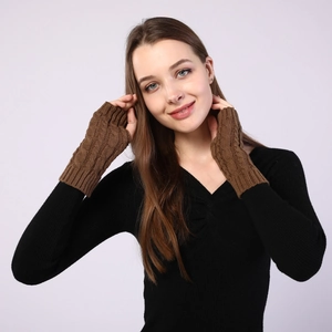 Close-up detail of cable knit texture on brown fingerless gloves with a long wrist design