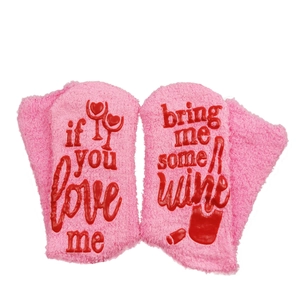 Pink plush funny socks with red anti-slip text 'bring me some wine' on white background