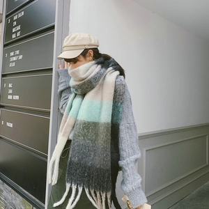 Street style view of multi-color rainbow plaid scarf with tassels and soft wool texture