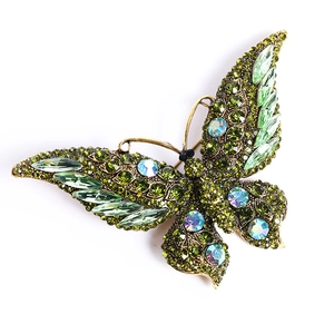 Vintage gold butterfly brooch with emerald green crystals and iridescent rhinestones