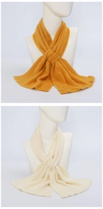 Detailed view of plush yellow and beige scarves with soft texture and knotted style