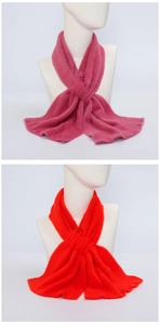 Detailed macro view of soft plush texture on pink and red winter scarf for women