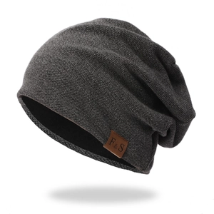 Detailed close-up of dark grey knit beanie with thick texture and F&S leather patch label