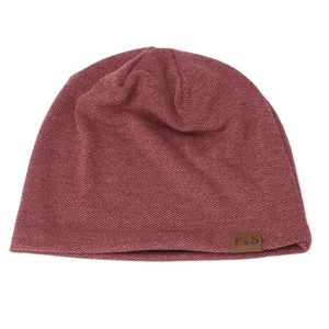 Close-up of deep red knit beanie featuring a brown leather F&S logo tag detail