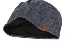Close-up of thick dark grey knitted beanie featuring warm black lining and F&S leather patch