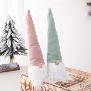 Pink and green Christmas gnomes with plush beards on decorative book boxes