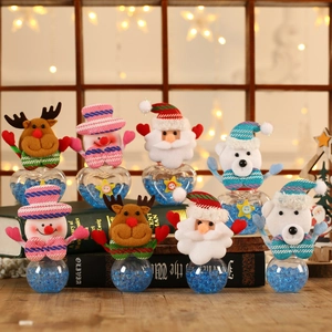 Mini Christmas candy jars set with Santa, reindeer, and snowmen on transparent bases