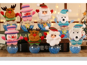 Close-up of Christmas candy jars with Santa, reindeer, and snowman fabric characters