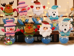 Detail of Christmas candy jars with Santa, snowman, and reindeer figures on books